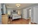 Comfortable bedroom with hardwood floors, an iron bed frame, and plenty of natural light at 3812 Vesta Dr, Raleigh, NC 27603