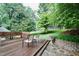 Outdoor deck with stone steps and white seating at 3812 Vesta Dr, Raleigh, NC 27603