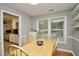 Cozy dining room with natural light and light wood table, chairs, and flooring at 3812 Vesta Dr, Raleigh, NC 27603