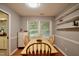 Cozy dining area features bright natural light, and simple shelving with hardwood table and chairs at 3812 Vesta Dr, Raleigh, NC 27603