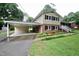 Charming home with a convenient carport, showcasing a blend of brick, siding, and a well-manicured lawn at 3812 Vesta Dr, Raleigh, NC 27603