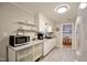 Open kitchen featuring white appliances, gray countertops, and ample storage space at 3812 Vesta Dr, Raleigh, NC 27603