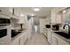 Spacious kitchen featuring white cabinets, stainless appliances, and gray granite counters at 3812 Vesta Dr, Raleigh, NC 27603