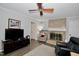 Comfortable living room featuring a brick fireplace, ceiling fan, and hardwood floors at 3812 Vesta Dr, Raleigh, NC 27603