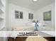 Bright bedroom featuring twin beds, three windows, and neutral walls at 407 Coolidge St # A, Chapel Hill, NC 27516