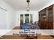 Charming dining room with a view of the screened-in porch, hardwood floors, and classic dining set at 407 Coolidge St # A, Chapel Hill, NC 27516