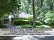 Charming single-story triplex with brick and white siding nestled among lush greenery at 407 Coolidge St # A, Chapel Hill, NC 27516