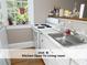 Bright kitchen featuring white cabinets, a stainless sink, and a window looking out to a green space at 407 Coolidge St # A, Chapel Hill, NC 27516