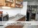 Efficient kitchen featuring a stainless steel sink, open shelving, and modern appliances at 407 Coolidge St # A, Chapel Hill, NC 27516
