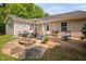 Relaxing backyard featuring a patio with seating, a fire pit, and a beautifully landscaped yard at 413 Braxman Ln, Holly Springs, NC 27540