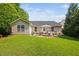 Spacious backyard featuring a patio, fire pit, and lush green lawn for outdoor enjoyment at 413 Braxman Ln, Holly Springs, NC 27540