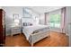 Bright bedroom featuring wood floors, a large window, and white furniture at 413 Braxman Ln, Holly Springs, NC 27540