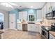 Bright kitchen featuring stainless appliances, white cabinets, and tile backsplash at 413 Braxman Ln, Holly Springs, NC 27540