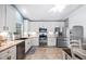 Spacious kitchen with white cabinets, stainless steel appliances, and tile flooring at 413 Braxman Ln, Holly Springs, NC 27540