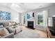 Cozy living room featuring a fireplace, neutral decor, and plenty of natural light at 413 Braxman Ln, Holly Springs, NC 27540