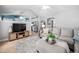 Comfortable living room with a large sectional sofa and contemporary decor at 413 Braxman Ln, Holly Springs, NC 27540