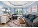 Comfortable living room with blue accent wall, natural light, and stylish furnishings at 413 Braxman Ln, Holly Springs, NC 27540