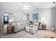 Spacious living room with large sectional and ample seating, with a view to the entryway at 413 Braxman Ln, Holly Springs, NC 27540