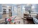 Stylish living room open to the kitchen, showcasing a modern and inviting space at 413 Braxman Ln, Holly Springs, NC 27540