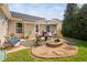 Charming patio with outdoor seating, grill, and fire pit, perfect for entertaining guests at 413 Braxman Ln, Holly Springs, NC 27540