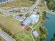 Aerial view of a community pool, lake, and clubhouse with outdoor seating area at 428 Mill Station Ln, Wendell, NC 27591
