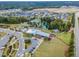 Aerial view of the community featuring a pool, lake, playground, clubhouse, and lush green spaces at 428 Mill Station Ln, Wendell, NC 27591