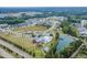 An aerial view showing a community pool, clubhouse, lake, and new construction homes at 428 Mill Station Ln, Wendell, NC 27591
