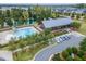 Aerial view showcases a community pool, pond, clubhouse, and parking area at 428 Mill Station Ln, Wendell, NC 27591