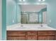 Dual sinks with dark wood cabinets, a large mirror, and updated fixtures in a modern bathroom at 428 Mill Station Ln, Wendell, NC 27591