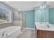 Bright bathroom featuring a soaking tub and a separate glass-enclosed shower with neutral tile at 428 Mill Station Ln, Wendell, NC 27591