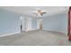 Spacious bedroom with carpet floors, ceiling fan, and multiple entry doors at 428 Mill Station Ln, Wendell, NC 27591