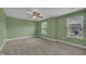A large carpeted bedroom has natural lighting and a ceiling fan at 428 Mill Station Ln, Wendell, NC 27591