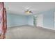 Bedroom with carpet floors, ceiling fan, and multiple entry doors at 428 Mill Station Ln, Wendell, NC 27591