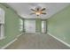 A carpeted bedroom with a ceiling fan offers natural lighting and closet space at 428 Mill Station Ln, Wendell, NC 27591
