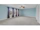 Spacious bedroom with carpet floors, ceiling fan, and multiple windows allowing natural light at 428 Mill Station Ln, Wendell, NC 27591
