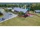 Stunning aerial view of clubhouse with outdoor seating, parking, and landscaping in a beautiful community setting at 428 Mill Station Ln, Wendell, NC 27591