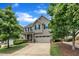 Two-story home with a two-car garage, a well-manicured lawn, and mature trees at 428 Mill Station Ln, Wendell, NC 27591