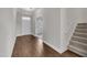 Foyer with hardwood floors, a staircase, and a view into an adjacent room at 428 Mill Station Ln, Wendell, NC 27591