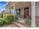 Home's inviting front porch with stone accents, steps, and colorful potted plants at 428 Mill Station Ln, Wendell, NC 27591