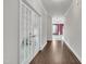 Hallway featuring hardwood floors, a view through French doors, and recessed lighting at 428 Mill Station Ln, Wendell, NC 27591
