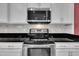 Stainless steel appliances, white cabinets and granite countertops add value to the kitchen at 428 Mill Station Ln, Wendell, NC 27591
