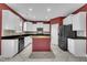Bright kitchen features white cabinets, stainless appliances, black countertops, and a center island at 428 Mill Station Ln, Wendell, NC 27591