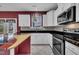 Kitchen with granite counters, modern appliances, white cabinetry and access to back patio at 428 Mill Station Ln, Wendell, NC 27591