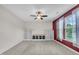 Living room featuring carpeted floors, ceiling fan, and built-in shelving at 428 Mill Station Ln, Wendell, NC 27591