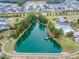 Overhead view of a community pond with a pier, surrounded by walking paths, a pool, and a clubhouse in a residential area at 428 Mill Station Ln, Wendell, NC 27591