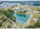 Beautiful aerial view of a community pond with a pier, walking trails, pool, and clubhouse, perfect for outdoor enjoyment at 428 Mill Station Ln, Wendell, NC 27591