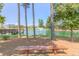 Tranquil pond view with a wooden bench, fountain, tall pine trees, and lush landscaping at 428 Mill Station Ln, Wendell, NC 27591