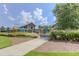 Community pool area with a waterslide, lounge chairs, a clubhouse, and manicured lawns under a bright sky at 428 Mill Station Ln, Wendell, NC 27591