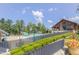 Community pool area featuring a pool with waterslide, a covered clubhouse, and well-manicured landscaping at 428 Mill Station Ln, Wendell, NC 27591