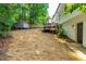 View of the backyard featuring a deck, shed, new wooden fence, and exterior basement entrance at 4349 Pickwick Dr, Raleigh, NC 27613